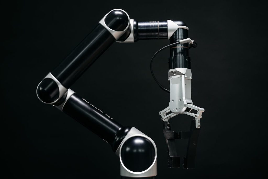 pexels photo 8438865 Close-up of a mechanical robotic arm with a dark background, showcasing advanced technology.