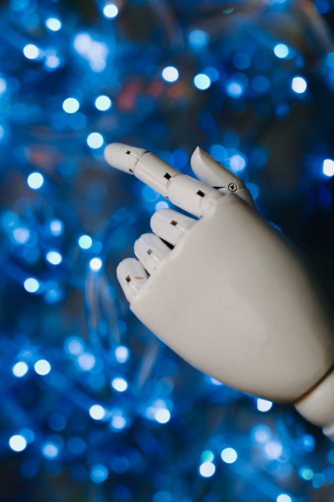 pexels photo 8849287 Close-up of a robotic hand with glowing blue bokeh background, symbolizing advanced technology.