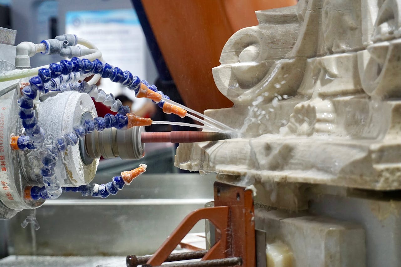 Close-up of a robotic machine sculpting stone with high precision in an industrial setting.